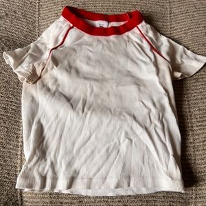 White ribbed shirt with red collar.